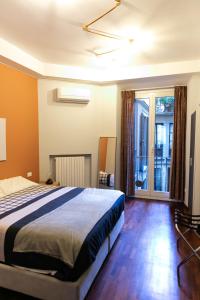 a bedroom with a large bed and a balcony at sweet house deluxe in Milan