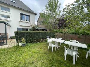 サン・ブリューにあるMaison spacieuse avec jardin et salle de sportの庭の白いテーブルと椅子