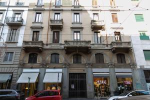 a building with a red car parked in front of it at sweet house deluxe in Milan