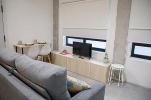 sala de estar con sofá y TV en Ponteloft - Recuncho, en Pontevedra