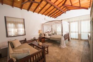 a living room with a bed and a couch at The Horizon Hill Top Villa in Unawatuna