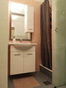 a bathroom with a sink and a mirror at Cosy condo in the heart of the Upper town Zagreb in Zagreb