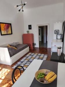 a living room with a table with a bowl of fruit at Cosy condo in the heart of the Upper town Zagreb in Zagreb