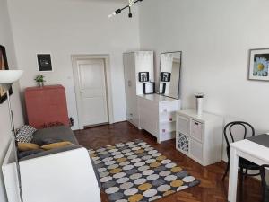 a living room with a table and a mirror at Cosy condo in the heart of the Upper town Zagreb in Zagreb