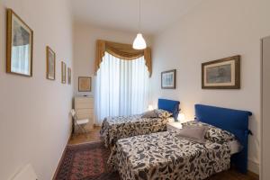 ein Hotelzimmer mit 2 Betten und einem Fenster in der Unterkunft Leopolda Dream Home in Florenz