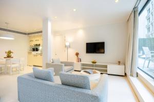 a living room with a couch and a tv at B-aparthotel Regent in Brussels