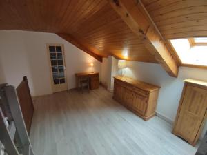 an attic room with a wooden ceiling and a window at Appartement T3 50m² - 6 pers. - Barcelonnette in Barcelonnette
