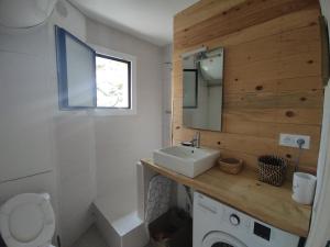 a bathroom with a sink and a toilet and a mirror at Appartement T3 50m² - 6 pers. - Barcelonnette in Barcelonnette