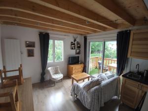 a living room with a couch and a table at Appartement T3 50m² - 6 pers. - Barcelonnette in Barcelonnette
