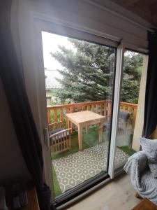 a sliding glass door leading to a patio with a table at Appartement T3 50m² - 6 pers. - Barcelonnette in Barcelonnette