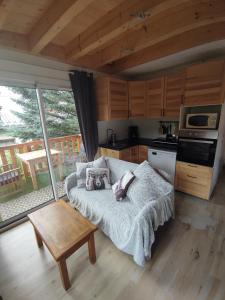 a living room with a couch and a table at Appartement T3 50m² - 6 pers. - Barcelonnette in Barcelonnette