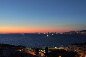 a view of the ocean at sunset at Penthouse with unique sea view and private terrace in Konak