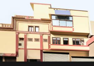 a tall building with many windows on it at Hotel sunrise in Lucknow