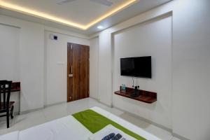 a white room with a flat screen tv on a wall at StayBird - NEST, A Premium Residences, Kharadi in Pune