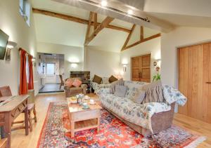 a living room with a couch and a table at Pandy Barn in Berriew