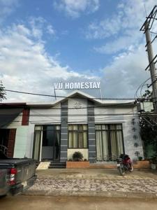 a white building with a sign on top of it at Vũ Homestay in Cao Bằng