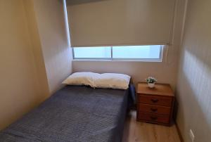 niewielka sypialnia z łóżkiem i oknem w obiekcie Acogedor departamento con vista al mar w mieście Lima