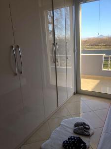 a bathroom with a shower and a towel on the floor at Villa Castle View in Shkodër +63 photos