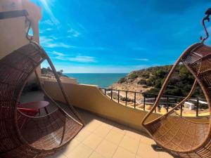 two hammocks on a balcony with a view of the ocean at Apartamento Bela Vista Leni in Poço Partido
