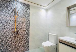 a bathroom with a shower with a toilet and a sink at Starry View in Hulhumale