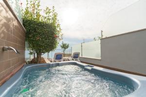 Garda Suite Hotel في ليموني سول غاردا: حوض استحمام ساخن في الحديقة الخلفية للمنزل