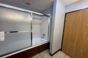 a bathroom with a shower and a bath tub at Fairway Inn Florence Indiana in Florence