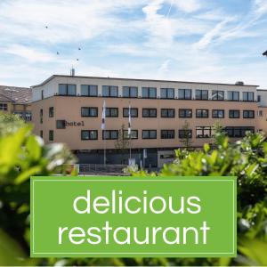 a building with a sign that reads deductible restaurant at b-smart hotel Schönenwerd in Aarau