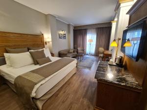 a hotel room with a bed and a living room at Hotel Crown Plaza Islamabad in Islamabad