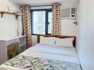 a small bedroom with a bed and a window at Dreamy Sunset Bay in Manila +231 photos