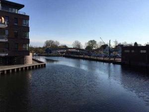 a body of water with a building and a bridge at Buxtepartment 