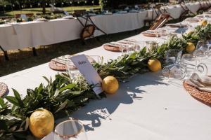 a table with a white table cloth with flowers and lemons at Villa Il Padule in Bagno a Ripoli