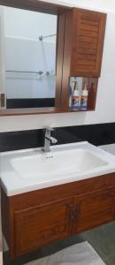 a bathroom sink with a mirror above it at Illumination Stay in Negombo