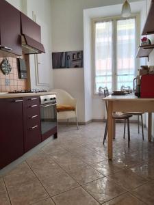 una cucina con tavolo e una cucina con piano cottura di ALLOGGIO CENTRALISSIMO SANREMO a Sanremo