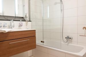 a bathroom with a shower and a sink and a tub at Apartment Ohragrund in Oberhof +27 photos