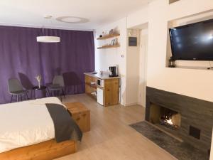 a hotel room with a bed and a fireplace at MiddleHouse in Braşov