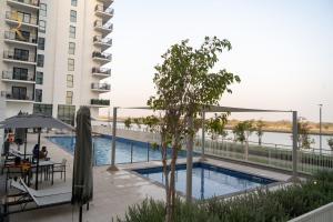 a swimming pool on the balcony of a building at Twilight 1BR apartment Yas Island in Abu Dhabi