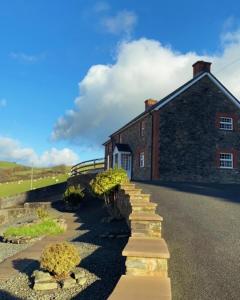 a brick building with a staircase leading up to it at Sunnyside hottub Brecon Beacons sleeps 8 in Lower Chapel