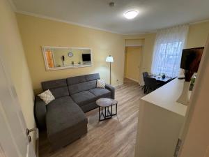 a living room with a couch and a table at Pension Auszeit Ferienwohnung in Bad Neuenahr-Ahrweiler