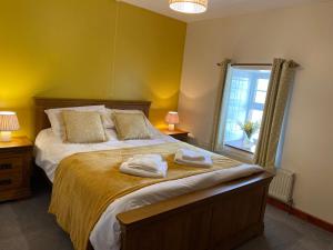 a bedroom with a bed with towels on it at Sunnyside hottub Brecon Beacons sleeps 8 in Lower Chapel