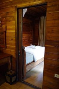 リペ島にあるAnda Lipe Resortの木製の部屋にベッド1台が備わるベッドルーム1室があります。