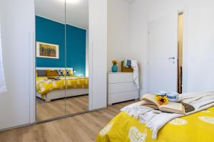 a bedroom with a mirror and a bed at [Arona Centro] Blue Lake - Wi-Fi in Arona