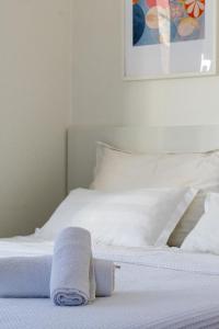 a white bed with a towel on top of it at Rooms Gold in Split