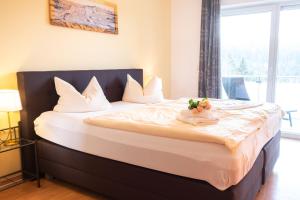a bedroom with a large bed with flowers on it at Haus Ohragrund in Oberhof