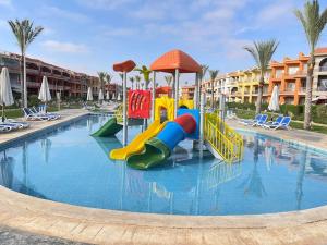 a swimming pool with a slide in a resort at Porto Matrouh unique Chalet in Marsa Matruh