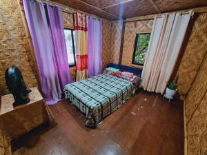 an overhead view of a bedroom with a bed and windows at Shey's Travellers Inn in Mambajao
