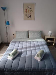 a bedroom with a large bed with two pillows on it at Serene Country House (near Ancient Tiryns) in Nafplio