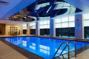 a large swimming pool in a building with a ceiling at FLY INN BAKU in Baku