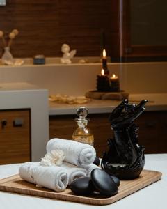a wooden cutting board with towels and a black statue at FLY INN BAKU in Baku