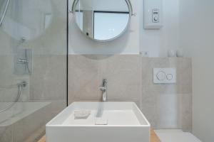 a bathroom with a white sink and a mirror at App Nordseeperle in List