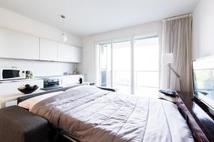 a bedroom with a large bed and a large window at Bertelli 4 in San Lazzaro di Savena